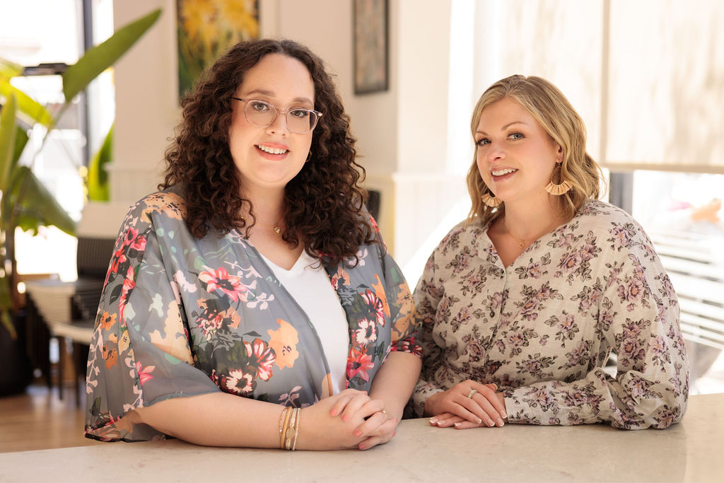 Nicole and Maureen co founders of Revonish side by side at coffee bar